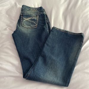 Silver Jeans Suki Mid Rose Bootcut Denim Embroidered Details and Distress Fade.